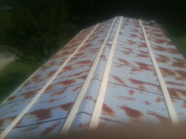 Rusted metal roof panels with new wood purlins before replacement — Storm Damage Roof Repair in Canby by Roofing Brothers
